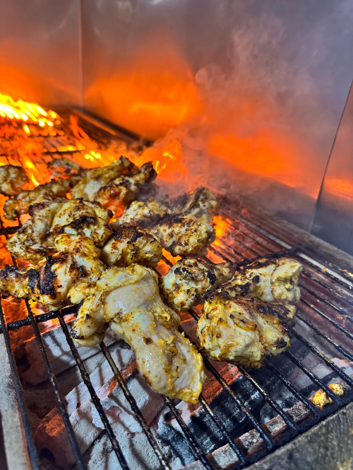 Chicken engulfed in flames on the grill