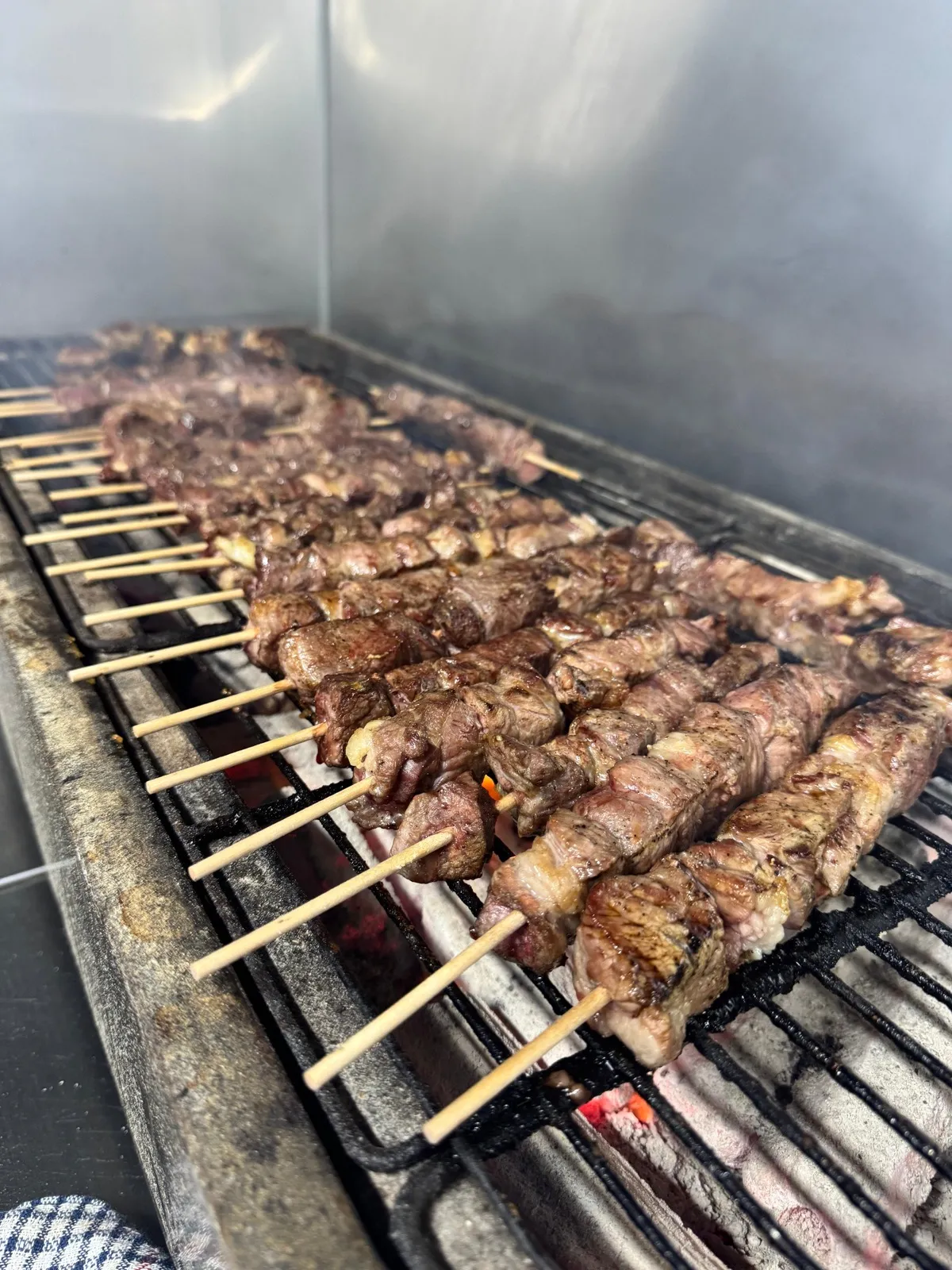 Lamb skewers flame-grilled on charcoal BBQ Punchbowl